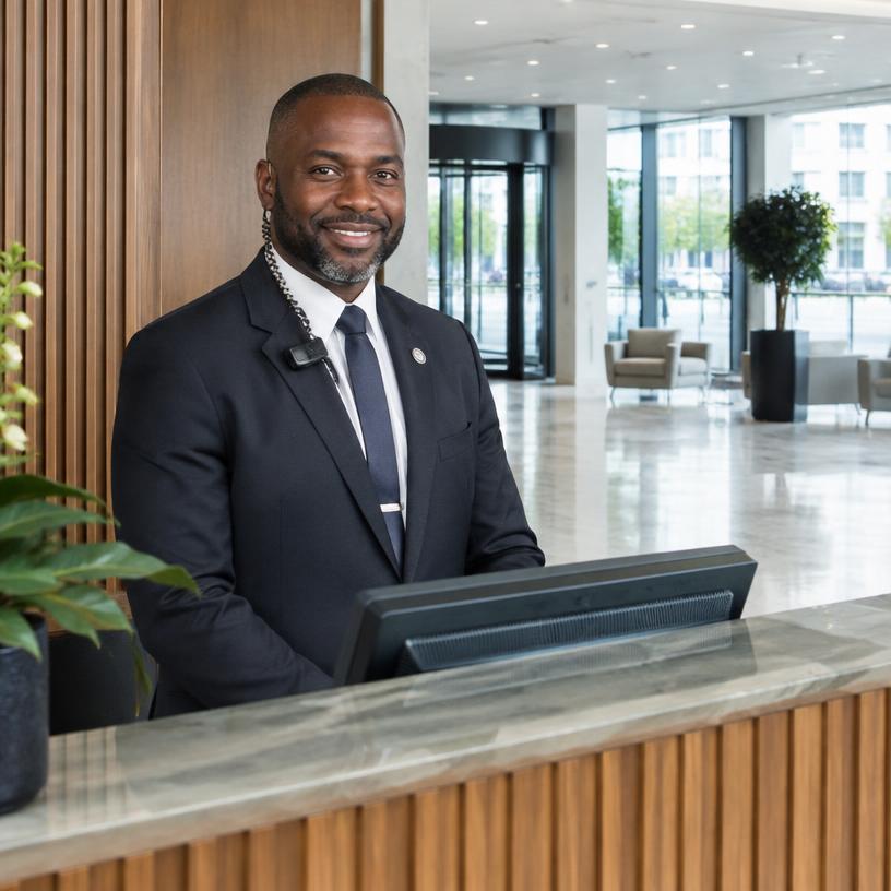 Concierge security officer at a modern reception desk